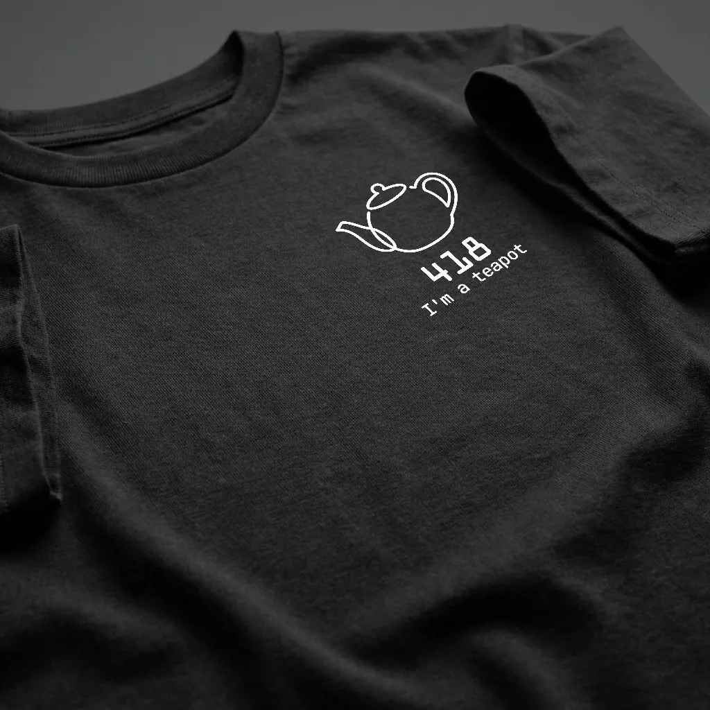 A close-up of a black t-shirt printed with a line-drawn teapot and the words 418, I'm a teapot